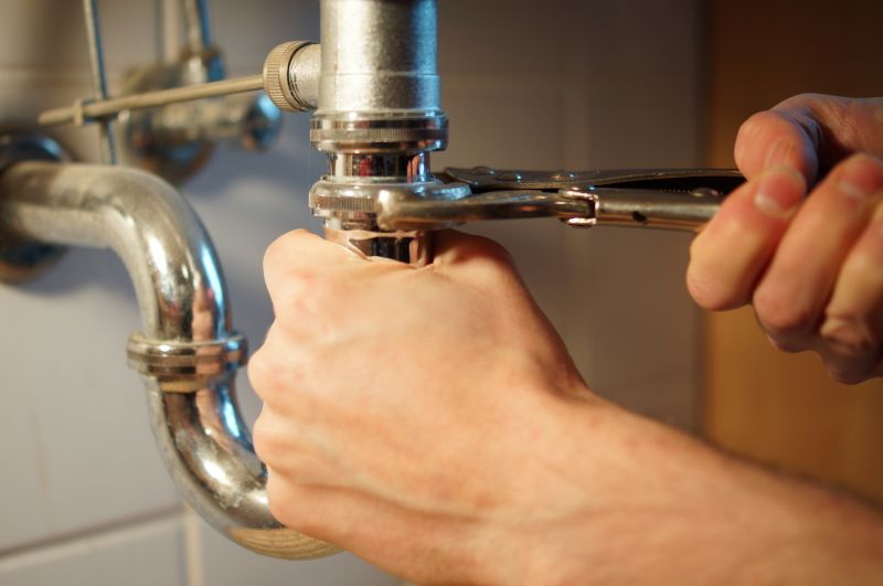 Plumber working on pipe system